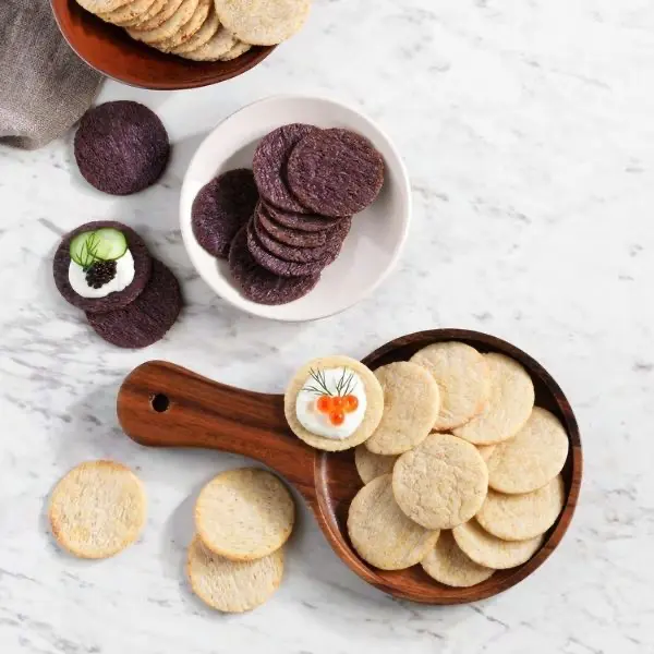 Assorted organic crackers displayed in bowls and plates